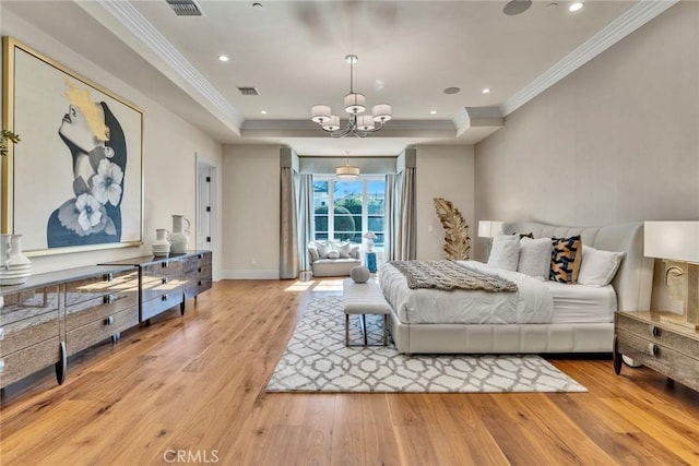 bedroom featuring a raised ceiling, crown molding, light hardwood / wood-style floors, and an inviting chandelier