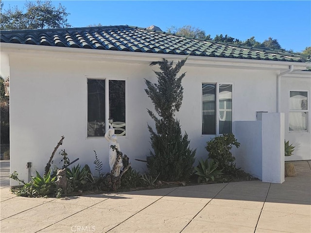 view of side of home featuring a patio