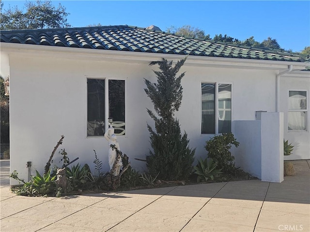 view of property exterior with a patio