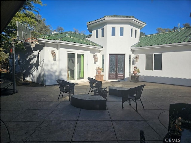 back of house with a patio and french doors