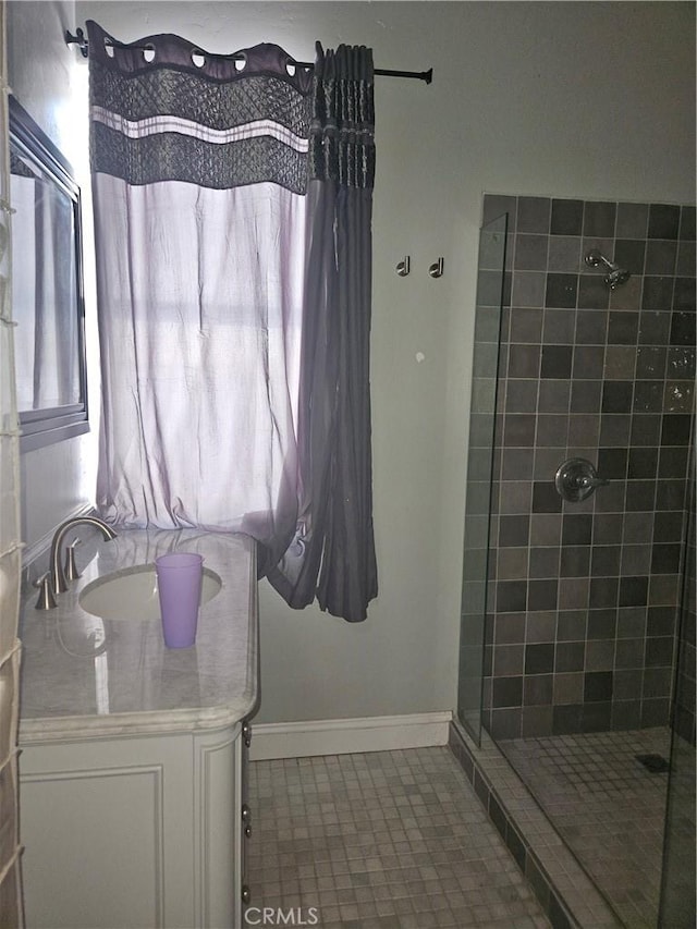 bathroom with sink and tiled shower