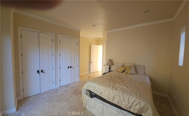 bedroom with multiple closets and ornamental molding