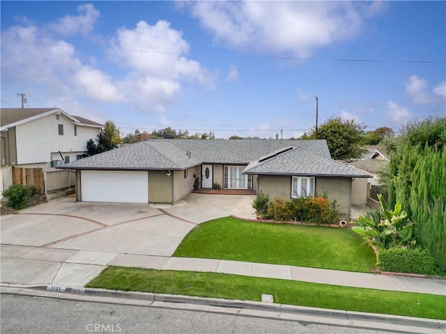 ranch-style house with a garage and a front lawn