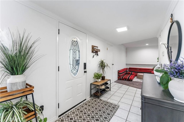 tiled foyer featuring crown molding