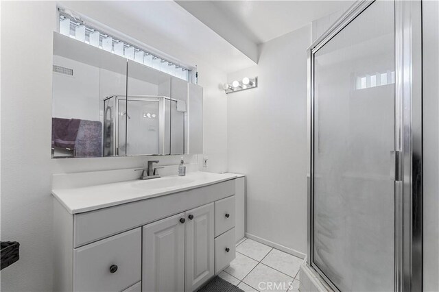 bathroom featuring tile patterned floors, vanity, and walk in shower