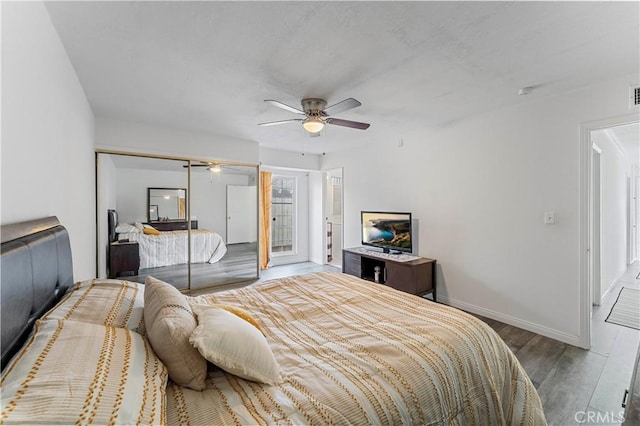 bedroom with hardwood / wood-style floors, a closet, and ceiling fan