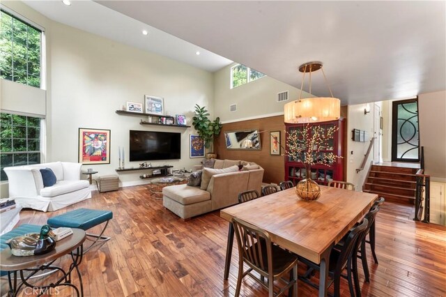 2355 N Beverly Glen Blvd, Los Angeles, CA 90077 - dining area with healthy amount of natural light, a towering ceiling, hardwood / wood-style flooring, recessed lighting, and stairway