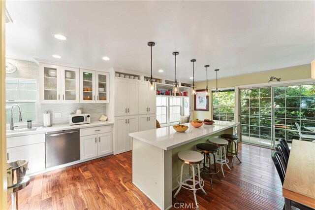 2355 N Beverly Glen Blvd, Los Angeles, CA 90077 - kitchen with stainless steel dishwasher, white microwave, a sink, white cabinetry, and dark wood-style flooring