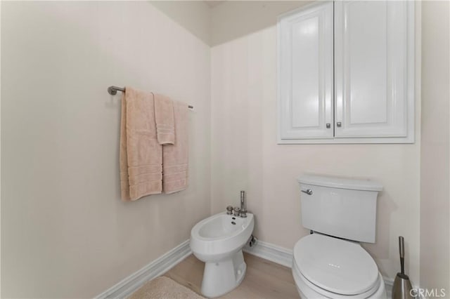 bathroom featuring a bidet, hardwood / wood-style floors, and toilet