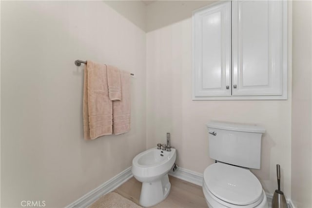 2355 N Beverly Glen Blvd, Los Angeles, CA 90077 - bathroom featuring a bidet, toilet, and baseboards
