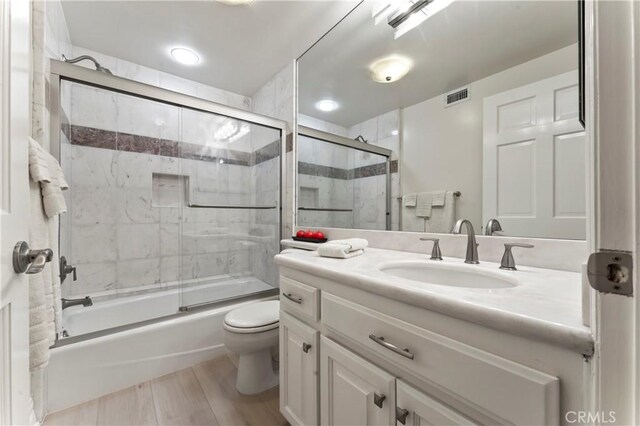 2355 N Beverly Glen Blvd, Los Angeles, CA 90077 - full bathroom featuring vanity, toilet, and shower / bath combination with glass door