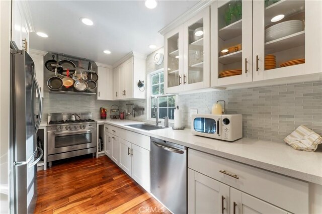 2355 N Beverly Glen Blvd, Los Angeles, CA 90077 - kitchen featuring appliances with stainless steel finishes, a sink, tasteful backsplash, white cabinets, and recessed lighting