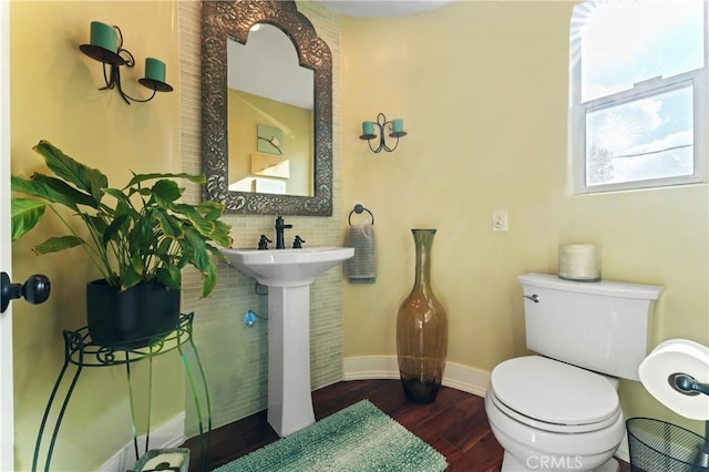 bathroom with hardwood / wood-style flooring, sink, and toilet