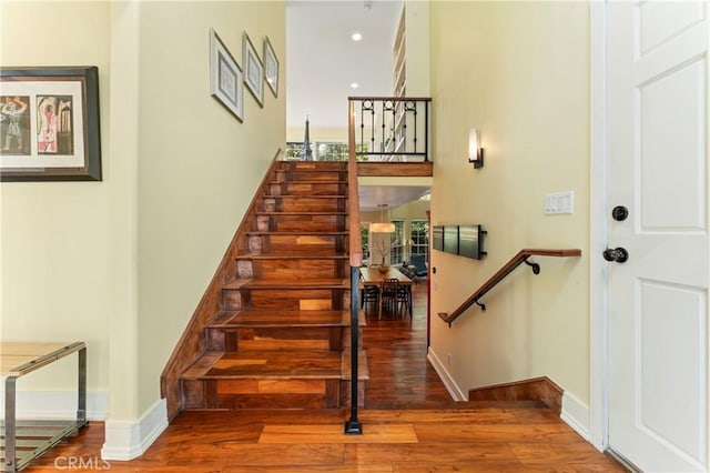 stairs with hardwood / wood-style flooring