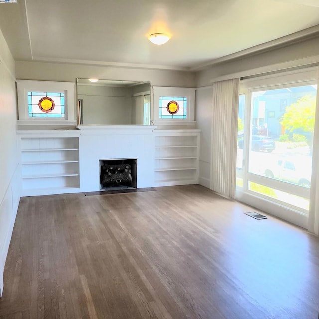 unfurnished living room with hardwood / wood-style flooring