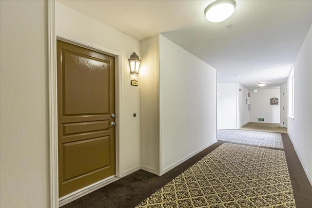 corridor with dark carpet