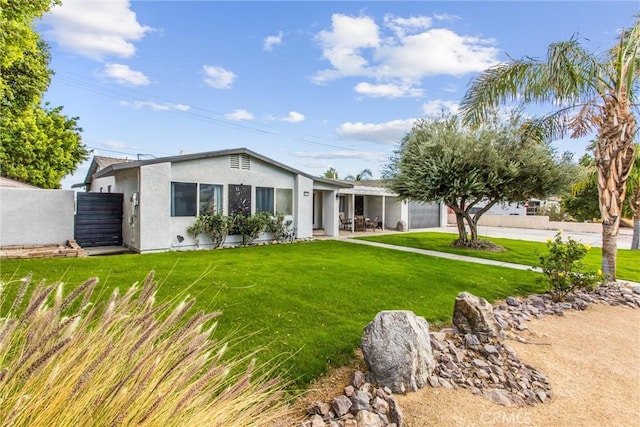 ranch-style home featuring a front yard