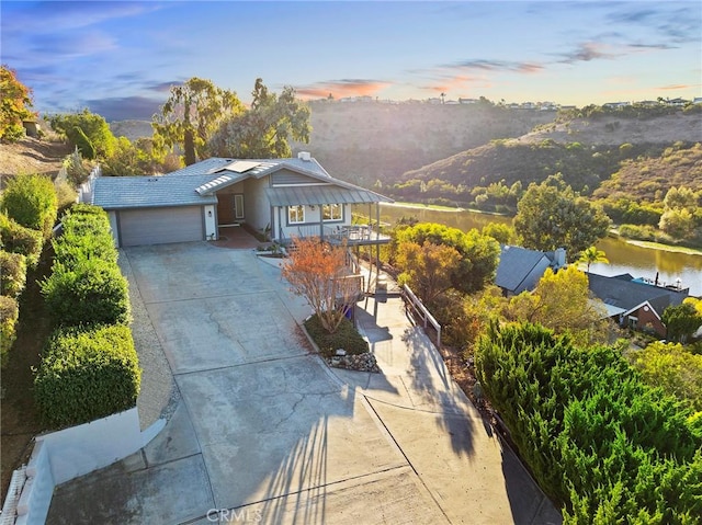 view of front of property with a water view and a garage