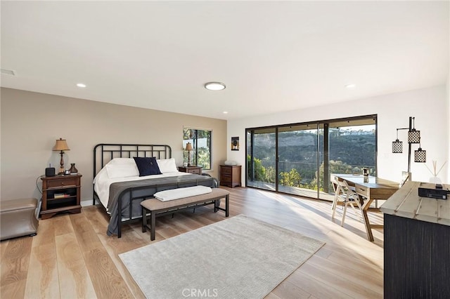 bedroom with access to exterior and light wood-type flooring