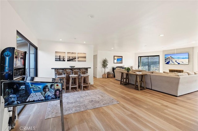 living room with light wood-type flooring and bar