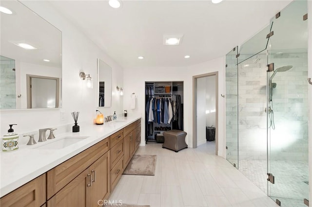 bathroom featuring vanity and a shower with shower door