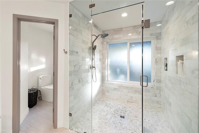 bathroom featuring tile patterned floors and a shower with shower door