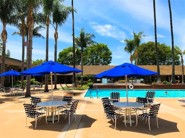 pool featuring a patio area and fence