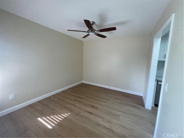 spare room featuring hardwood / wood-style flooring and ceiling fan