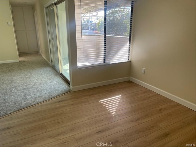 empty room with light hardwood / wood-style flooring