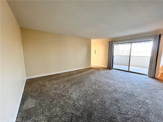 carpeted spare room with baseboards