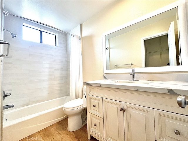 bathroom with shower / bath combination with curtain, vanity, toilet, and wood finished floors