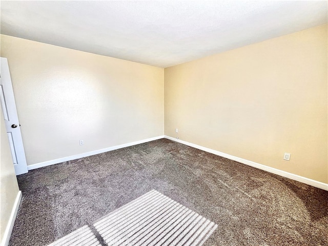 carpeted empty room with baseboards