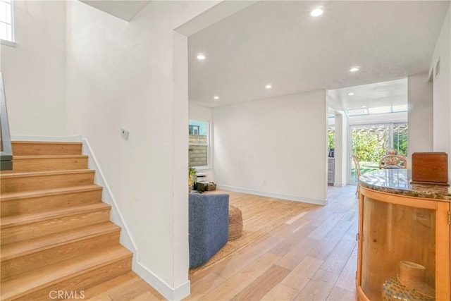 stairs with hardwood / wood-style floors