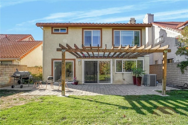 back of house featuring a patio, a lawn, a pergola, and central air condition unit