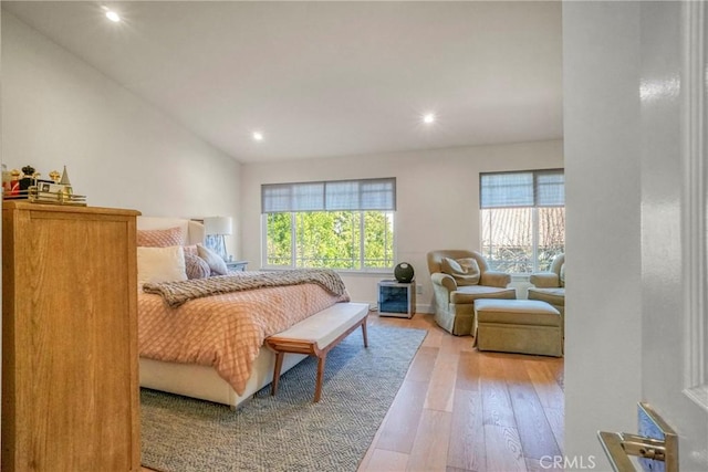 bedroom with light hardwood / wood-style flooring and lofted ceiling