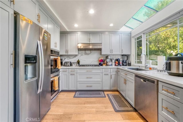 kitchen with gray cabinetry, sink, and appliances with stainless steel finishes