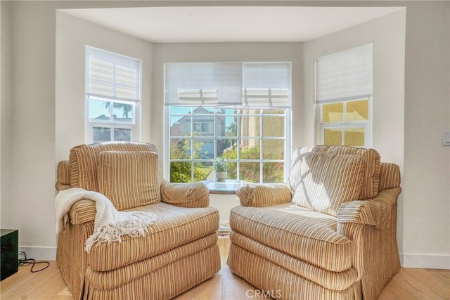 sitting room with plenty of natural light and light wood-type flooring