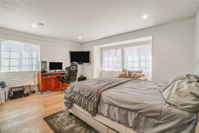 bedroom featuring multiple windows and hardwood / wood-style floors