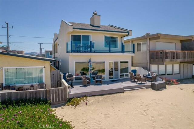 1652 Strand Way, Oceano, CA 93445 - rear view of house featuring an outdoor living space, a balcony, a chimney, stucco siding, and a deck