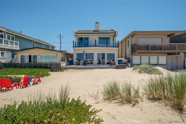 1652 Strand Way, Oceano, CA 93445 - back of house with a balcony, stucco siding, and a chimney