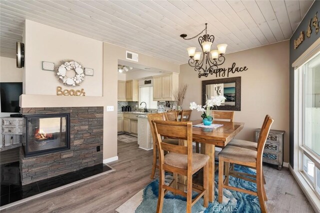 1652 Strand Way, Oceano, CA 93445 - dining room with wood ceiling, a chandelier, light wood-type flooring, and a fireplace