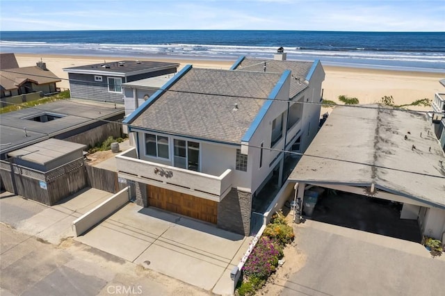 drone / aerial view featuring a view of the beach and a water view