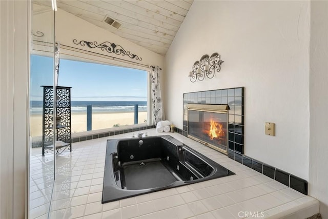 view of patio / terrace featuring a water view and a view of the beach