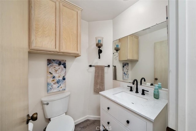 bathroom featuring hardwood / wood-style floors, vanity, and toilet