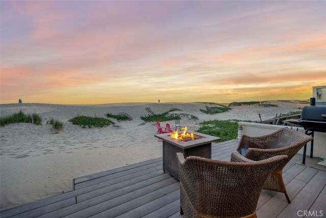 1652 Strand Way, Oceano, CA 93445 - deck at dusk featuring an outdoor fire pit and a water view