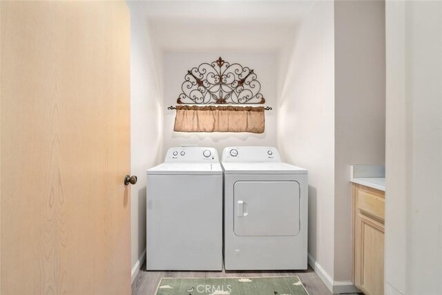 1652 Strand Way, Oceano, CA 93445 - laundry room with separate washer and dryer, cabinet space, and light wood-style floors