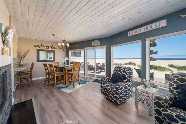 interior space featuring a water view, wood ceiling, and an inviting chandelier