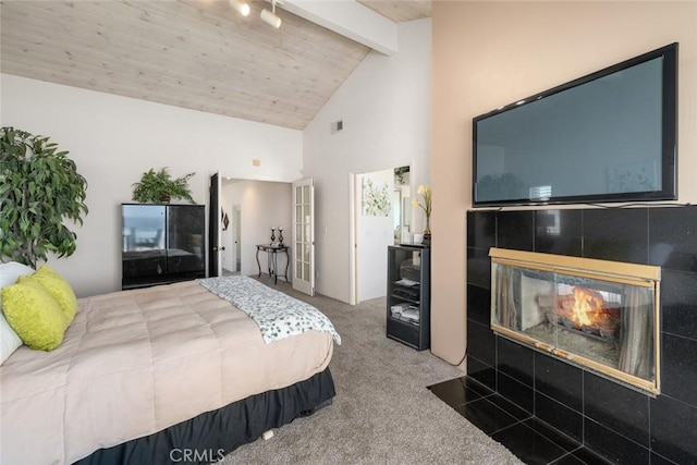 bedroom with carpet flooring, beam ceiling, high vaulted ceiling, wooden ceiling, and a multi sided fireplace