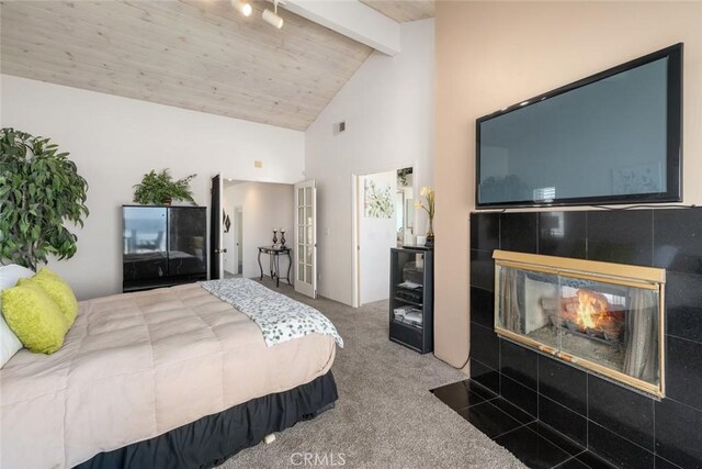 1652 Strand Way, Oceano, CA 93445 - carpeted bedroom featuring beamed ceiling, a tiled fireplace, and high vaulted ceiling