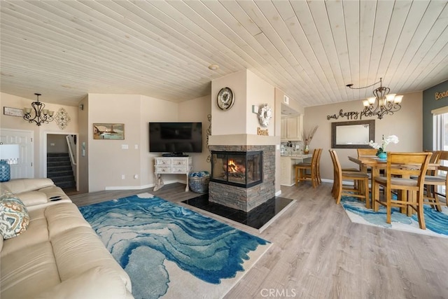 1652 Strand Way, Oceano, CA 93445 - living room featuring a chandelier, wood ceiling, stairs, light wood-style flooring, and a multi sided fireplace